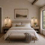 Brass twin-cylinder picture light in a bedroom