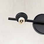 Round wall mounting detail on the matte-black picture light
