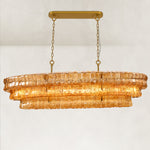 Amber glass linear chandelier with its canopy and chains.