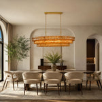 Amber glass rectangular chandelier in an arched-alcove dining room.