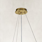brass-tone deep crystal-branch chandelier canopy detail.