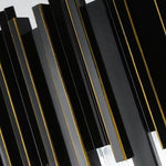 Close-up of black metal fins with gold-tone edges.