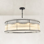 Black glass rod drum chandelier complete fixture illuminated against a light background