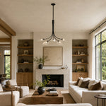 Black leaf glass chandelier above a living room seating area in an interior setting