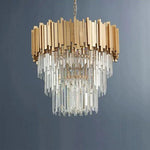 Unlit cascading crystal chandelier against a dark background.