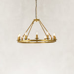 Gold-tone candle ring chandelier, illuminated complete product view.