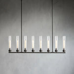 Eight clear glass cylinders on a black linear chandelier.
