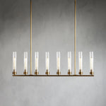 Eight clear glass cylinders on a brass-tone linear chandelier.