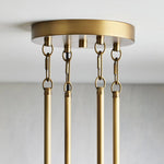 Brass-tone circular ceiling canopy with chain and rod attachments.