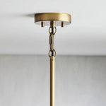 Brass-tone canopy and suspension connection for the single pendant.