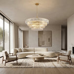 Clear round chandelier in a neutral living room.