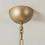Close-up of a gold-colored ceiling canopy and chain connection