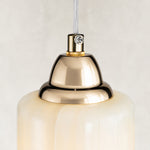 Gold-tone top hardware detail of the Cloud Onyx Cylinder Pendant