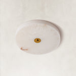 Unlit Cora alabaster ceiling light against a neutral background