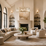 Brass crystal-bar drum chandelier in an arched fireplace living room.