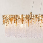 Gold-tone edge and textured clear panels of the chandelier.