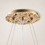 Round gold-tone ceiling canopy and suspension cables.