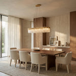 Gold-tone crystal-glass chandelier above a dining table.