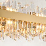 Illuminated clear rods along the oval chandelier band.