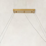 Rectangular chandelier canopy and suspension cables.