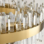 Clear faceted rods and gold-tone band of the round chandelier.