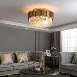 Crystal crown flush mount above a living room seating area.