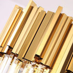 Close-up of the oval chandelier's gold-tone metal fins.