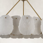 Gold-tone ring chandelier, white panels and suspension arms close view.