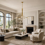 Gold-tone leaf glass chandelier in a living room with a fireplace
