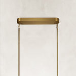 Gold-tone oval chandelier ceiling canopy and suspension close view