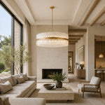 Glass drum chandelier above a stone coffee table facing a fireplace.