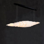 Angled illuminated selenite linear pendant with a black canopy.