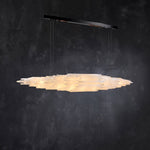 Angled illuminated selenite linear pendant with a black canopy.