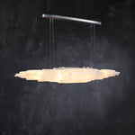 Angled illuminated selenite linear pendant with a silver-tone canopy.