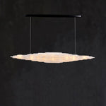 Front of a layered selenite linear pendant with a black canopy.