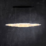 Front of an illuminated layered selenite pendant with a black canopy.