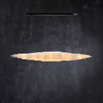 Front of an illuminated layered selenite pendant with a black canopy.