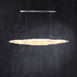 Front of an illuminated layered selenite pendant with a silver-tone canopy.