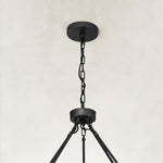 black two-tier glass-tube chandelier canopy detail.