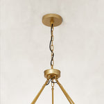 brass-tone two-tier glass-tube chandelier canopy detail.