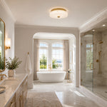 Low-profile textured glass flush mount shown in a bathroom interior