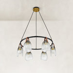 Ring chandelier with ribbed glass shades, complete fixture unlit.