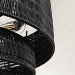 Black woven drum chandelier fixture detail.