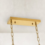 Gold-tone oval crystal chandelier, rectangular canopy and chains.