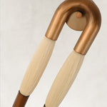 Off-white fiber and bronze-tone U-shaped sconce detail.