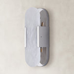 Unlit oval alabaster wall sconce with silver-tone hardware.