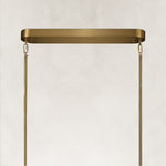 Brass-tone oval chandelier canopy and suspension rods.