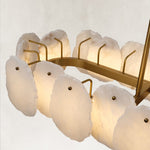 Illuminated petal panels and brass-tone oval frame.