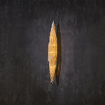 Angled profile of a narrow selenite wall sconce with pointed ends.