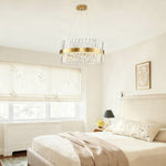 Brass round chandelier with crossing clear K9 crystal prisms